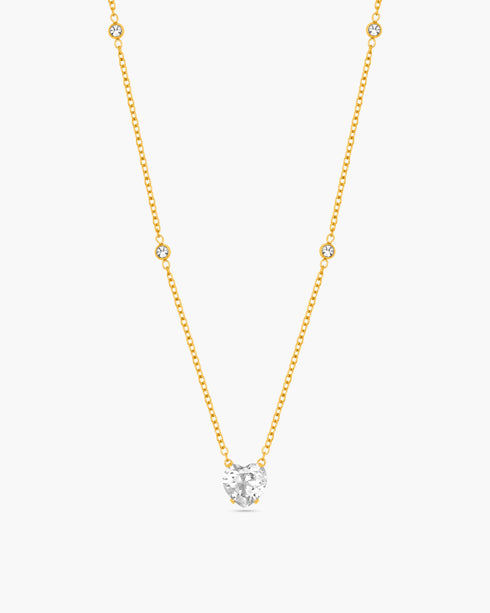 Gold necklace with a diamond pendant on a white background